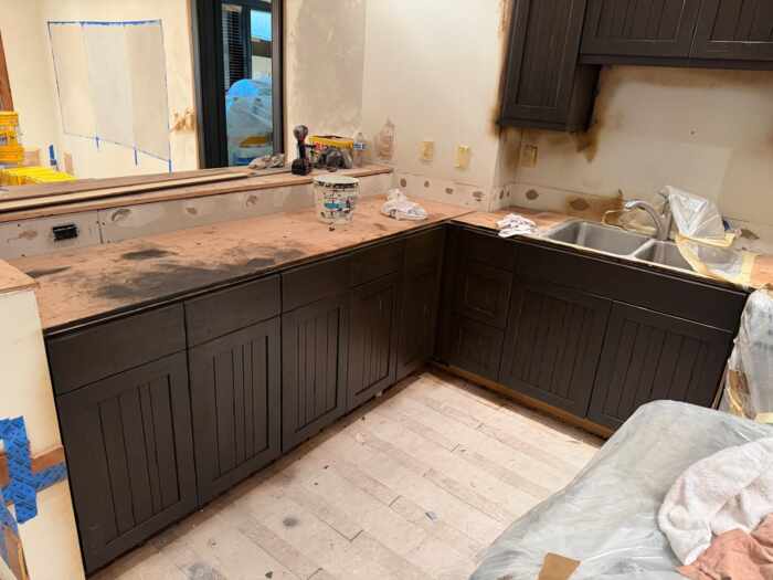 Kitchen cabinets being refinished in a dark color
