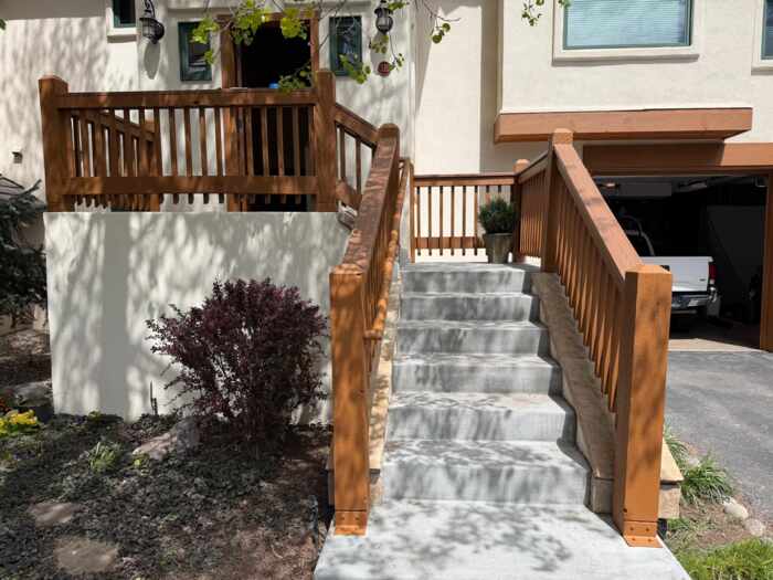 Freshly stained brown wood deck railing and stairs